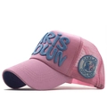 Detail of pink mesh trucker hat featuring blue 3D foam embroidery and side logo patch - All Pink