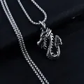 Macro shot of silver dragon pendant with detailed scales on black textured background - Flame Dragon + Stainless Steel Chain