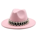 Detail of pink wool fedora hat featuring black ribbon and elegant faux pearls - Pink