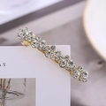 Elegante pinza de pelo de aleación dorada con diamantes de imitación sobre tarjeta blanca - Circonita Blanca