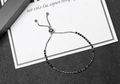 Detail of adjustable silver chain bracelet featuring a row of sparkling black rhinestones - Black