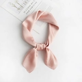 Close-up of a pink satin silk scarf tied neatly on a magazine with soft natural light - Light Pink
