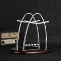 Newton's Cradle with silver metal balls and dark wooden base for office desk decor - Large Sail Shape