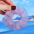 Detail of purple plaid organza scrunchie held by hand with a soft beach background - Purple Plaid