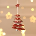 Macro shot of 3D layered wooden star ornament with festive silver bell and red star top - Five-pointed Star / Red