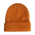 Detail shot of vibrant orange knitted beanie featuring dense fine texture and ribbed edge - Caramel