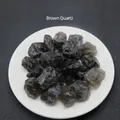 Natural brown quartz raw crystal stones displayed on a minimalist ceramic white plate - Smoky Quartz