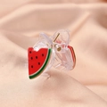 Detailed view of watermelon slice acetate hair claw clip on pink silk background - Watermelon Claw Clip