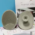 Gray-green silicone facial cleansing brush with dual-texture bristles and suction handle - Army Green