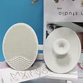 White soft silicone facial cleansing brush with dense bristles and suction handle - Light Gray