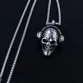 Macro detail of retro silver skull pendant wearing headphones on a steel pearl chain - Skull Headphone + Stainless Steel Chain