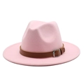 Detailed macro view of pink felt fedora with brown leather band and metal buckle strap - Pink