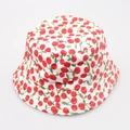 Detail shot of canvas sun hat featuring red cherry prints and white fabric texture - No.9 Cherry