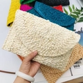 Detailed view of woven corn husk straw clutches in multiple vibrant colors and textures - Original Color