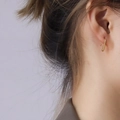 Minimalist 18K gold plated titanium teardrop hook earrings worn by a female model - Gold Color Small Waterdrop Earrings / One Pair