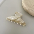 Macro shot of cream marble acetate hair claw showing smooth texture and strong teeth grip - Magic Khaki Crescent