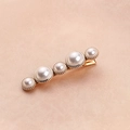 Detail showing five white pearls in gold settings on a delicate metal hair clip - 5 Pearls Hair Clip