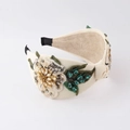 Macro shot of 3D white flower embroidery and emerald rhinestones on a wide headband - Light Yellow