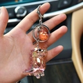 Iridescent pink acrylic dinosaur keychain with metal ring and orange bead accessory - Orange