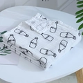 Soft muslin swaddle blanket featuring black milk bottle print on white cotton fabric - Black and White Milk Bottle