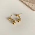 Detailed view of dual-ball gold stud earrings in S925 silver on minimalist stone decor - Double Sphere Studs / Gold