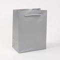 Detailed view of a silver cardboard gift bag with durable rope handles and glossy finish - 18*14*8cm / Silver