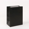Detailed view of a black cardboard gift bag with durable matching rope handles - 18*14*8cm / Black