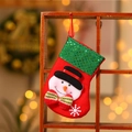 Detail of red Christmas stocking featuring a 3D snowman, green sequins, and a red hanging loop - Snowman / Small Sequin Sock