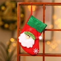 Detail of red Christmas stocking with green sequins and plush Santa Claus character - Santa Claus / Small Sequin Sock