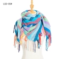 Colorful striped scarf with tassels on a white mannequin with vibrant geometric patterns - Blue