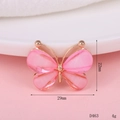 Detail shot of a small pink butterfly charm with gold metal frame and 29x22mm dimensions - D463 Translucent Butterfly (Pink)