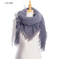 Thick grey knitted scarf with speckled texture and fringe details on a model - Gray