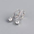 Detail view of silver hoop earrings with small crystals and hanging round cubic zirconia - 925 Silver / White Gold (Pair)