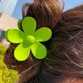 Neon green flower hair claw clip with matte finish worn on a classic hair bun - 7cm / Grass Green