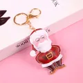 Christmas Santa Claus keychain with plush ball and gold lobster clasp on pink background - Light Gold Lobster Clasp Santa