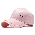 Détail de la casquette en satin rose avec logo M doré et bordure métallique - Réglable / Rose