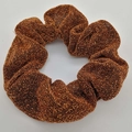 Elegant bronze metallic scrunchie with sparkling glitter texture and pleated fabric - Brown