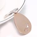 Llavero de gota en acero inoxidable oro rosa pulido con recortes de huellas de perro - Oro rosa