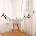 Silver Happy Birthday banner with party hat icon hanging in a bright cozy room - Birthday Hat Style / Silver