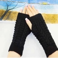 Detail of black cable-knit arm warmers fingerless gloves for winter warmth protection - One Size / Black