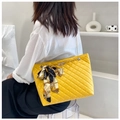 Detail of yellow quilted tote bag with gold chain strap and decorative silk scarf - Yellow