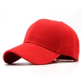 Detail of red six-panel baseball cap showing thick twill cotton fabric and curved brim - Red
