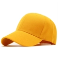 Detailed macro view of yellow cotton twill fabric and curved brim on a baseball cap - Orange