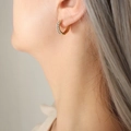 Polished 18K gold plated hoop earring with sparkling white zircon stones on model - Gold White Zirconia