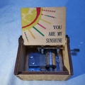 Handcrank wooden music box featuring You Are My Sunshine engraving and sun pattern - New Sunshine