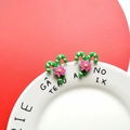 Detail of Christmas candy cane earrings with pink flowers on a green base - Green Candy Cane