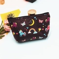 Detail of a purple unicorn coin purse showing colorful rainbow prints and a smooth black zipper - Unicorn-8