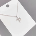 Detail shot of silver double cross pendant necklace with zircon crystals on display card - Silver