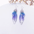 Detailed view of butterfly wing earrings with blue-purple gradient and silver foil inlay - Blue-Silver Foil