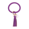 Close-up of purple leather keychain with tassel and rose gold ring on white background - Purple